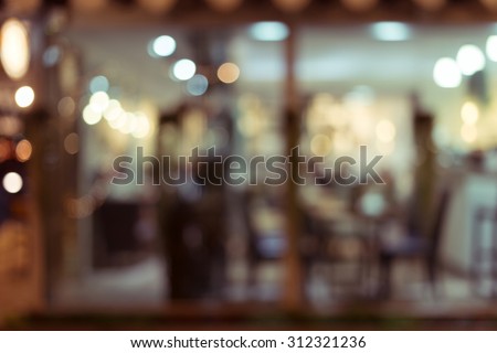 abstract blur image decoration interior restaurant with light glittering in the night