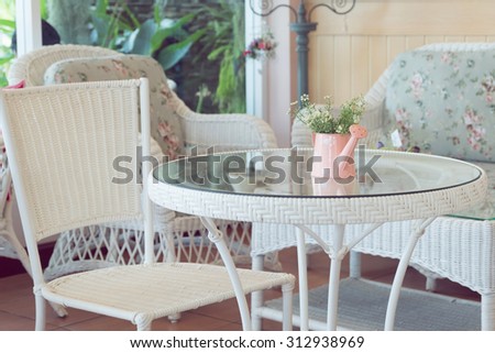 design of vintage style interior in cafe with flowers vase on white furniture