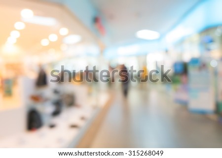 blur background, department store with storefronts fashion clothes