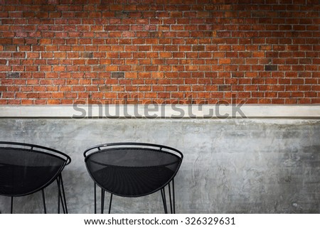 design of interior, counter bar made from cement with iron seat bar stool and brick wall background