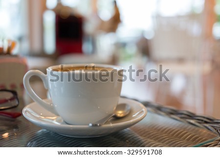 coffee cup on table with blur interior cafe coffee shop background