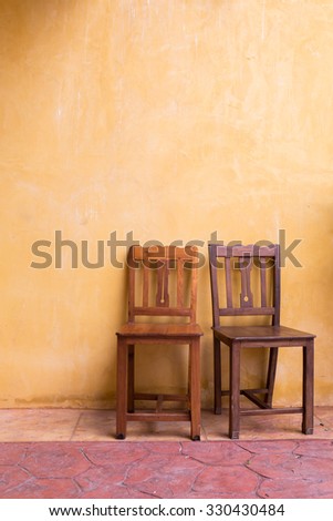 wooden chair seat and orange cement mortar wall background