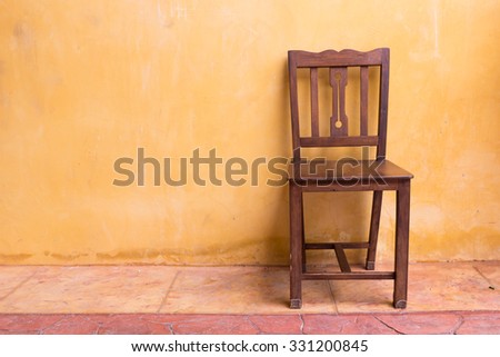 wooden chair seat and orange cement mortar wall background