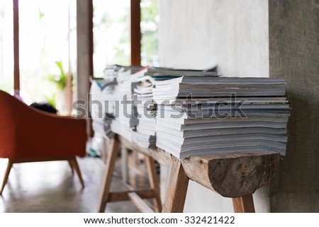 design of interior living room, stack of magazine books on wooden table shelf