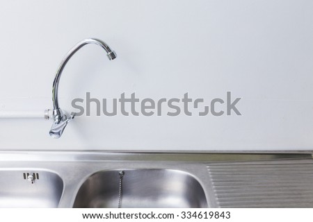 stainless steel sink and faucet in white kitchen room