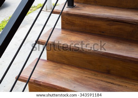 brown wooden staircase with iron banister in modern house