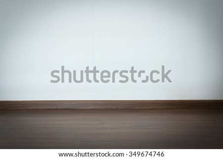 empty room, white mortar wall background and wood laminate floor in residential