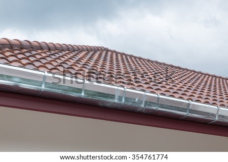 gutter roof residential building house in rainy day