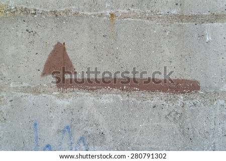 Turn left handpainted arrow on the concrete wall.