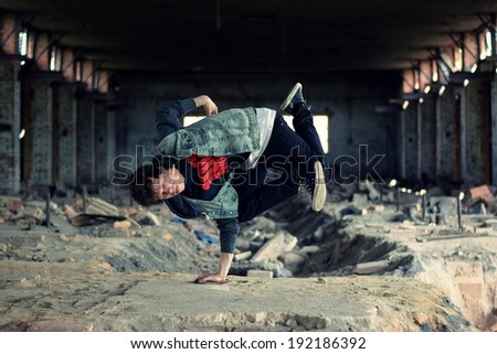 Teenager dancing break dance in the old brickworks