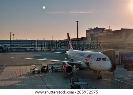 A commercial aircraft being serviced on the tarmac of an international airport Prague, 4.7.2014