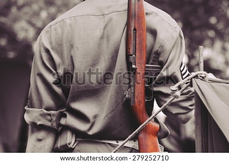 Soldier with a gun turned back