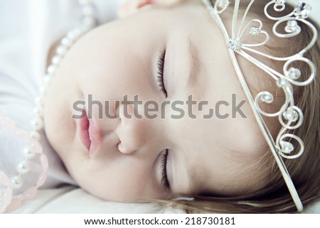 Little girl sleeping after playing princess
