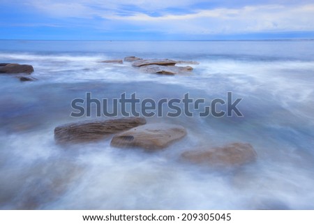Rocks and waves at Kings Beach - Sunshine Coast, QLD.