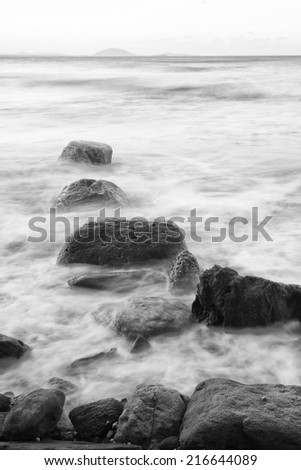 Black and white image of rocks at the beach in the Sunshine Coast, Queensland - Australia.
