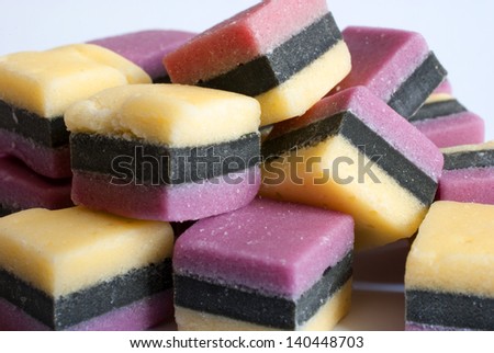 Sugar licorice candy with black stripes and white background