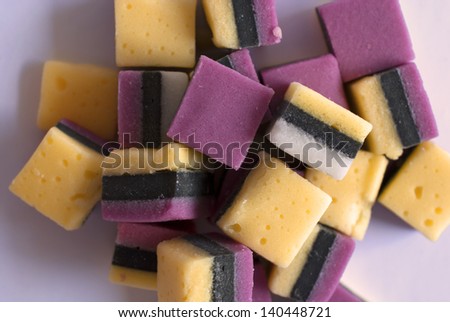 Sugar licorice candy with black stripes and white background
