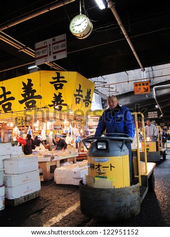 TOKYO - MARCH 23: Seafood merchant sell fish and seafood in Tsukiji fish market. It is the biggest wholesale seafood market in Japan March 23,2012 in Tokyo, Japan.