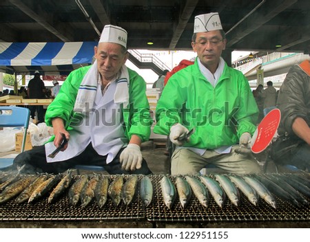 YOKOHAMA,JAPAN - OCTOBER 28: Merchants sell grilled fish at Yokohama fish market on October 28,2012. It is the biggest fish market in Yokohama.