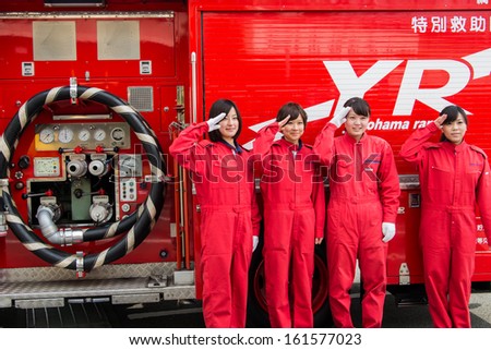 Kanagawa, Japan - January 5: Unidentified female firefighters greet beside the rescue car in the New Year\'s Fire Review at Nissan Stadium on January 5, 2013 in Kanagawa, Japan.