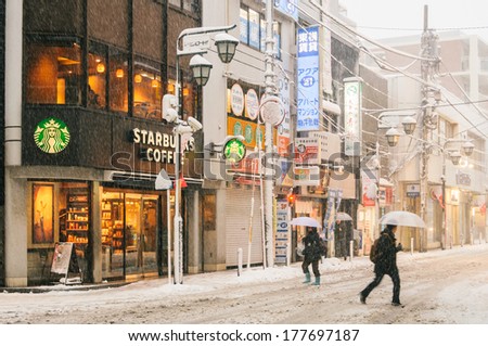 Yokohama, Japan - February 8, 2014: Japanese People Walks Across The Street In Snow Storm In Yokohama, Japan