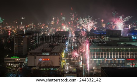 STUTTGART, GERMANY - JANUARY 1, 2015: View along the main shopping street, known as Koenigstrasse. In the center of the city, the citizens welcome the new year with individual fireworks.