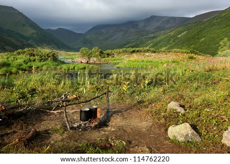 Kettle on a fire at a lake birch in mountains of the central Kamchatka in Russia in the summer