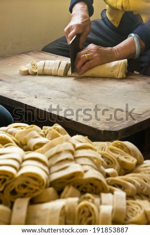 The process, cutting the whole to pieces, to make one kind of traditional food in China.