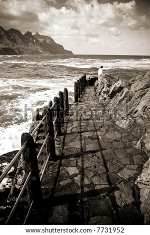 Girl at the end of a footpath, between earth, sea and air.