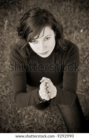 Woman praying to Lord in dark sepia