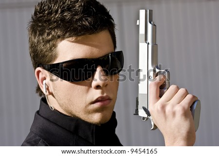 Male model performing secret agent with gun