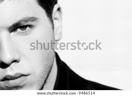 Unshaved handsome man portrait. Black and white isolated on white.