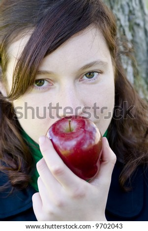 Green eyed young girl with apple
