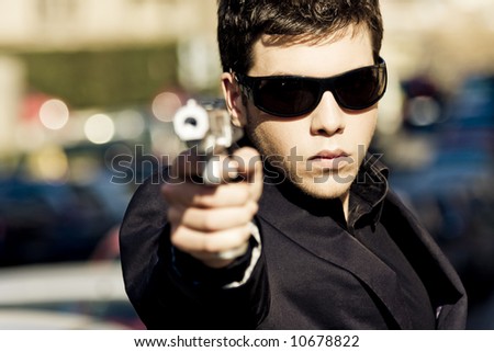 stock photo : Agent aiming with gun in the middle of the street. Weapon out