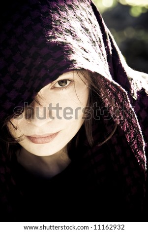 Staring woman portrait covered by violet veil