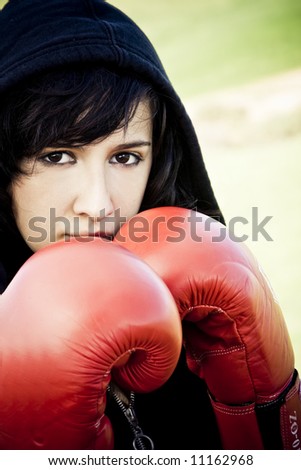 Young female boxer with red gloves