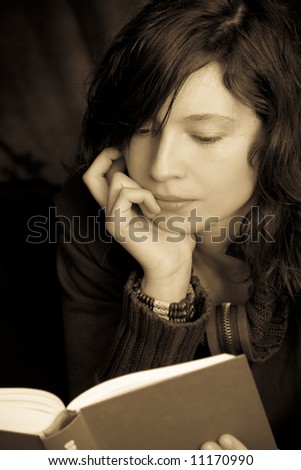 Reading woman portrait in gold sepia.