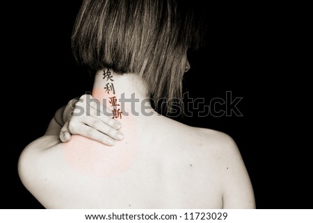 Short haired woman with asian tattoo in her neck feeling pain.