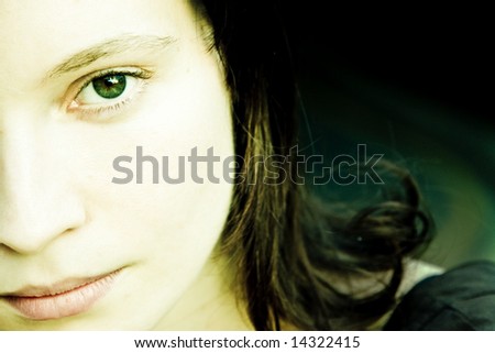 Half beauty portrait with impressive green eye.