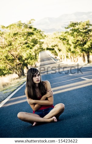 Lost beautiful girl in the middle of the road