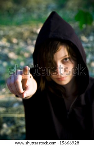 Young serious woman pointing at camera.