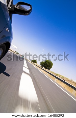 Blue car at high speed on the road