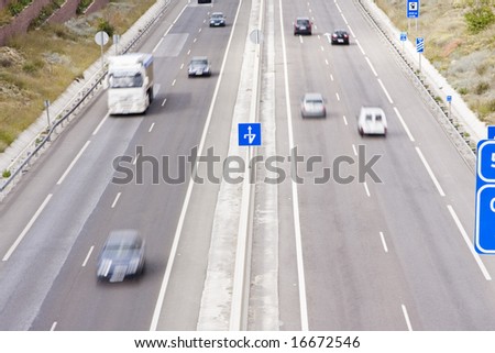 Highway full of blurred vehicles at high speed.