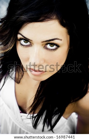 Young staring woman with awesome green eyes.