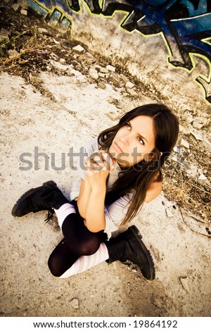 Young woman begging with sad expression in her face.