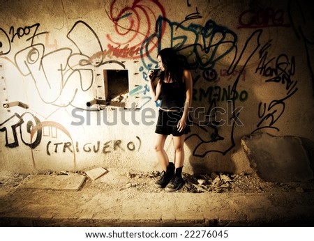 Sad gothic girl in dirty wall
