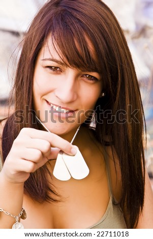 Young smiling woman showing her ID tag.