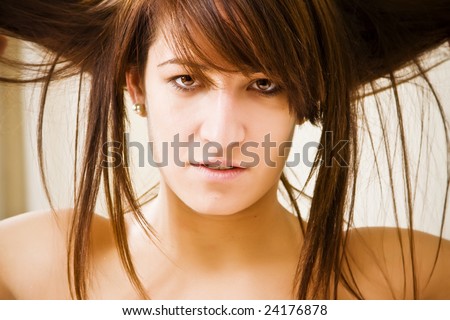 Young crazy hair woman sensually staring at camera.