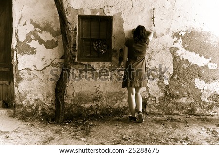 Young sad woman crying in wall