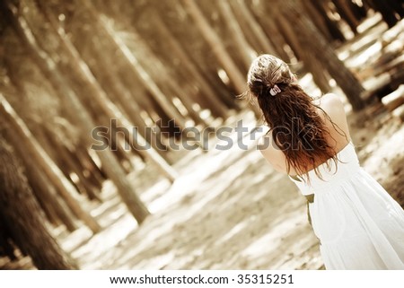 Young anonymous woman in the forest